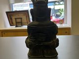 a statue of a man with a crown on top of a table