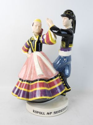 a figurine of a man and a woman dancing