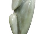 statue of a bird on a wooden base on a white background