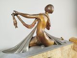 a statue of a woman sitting on top of a clock