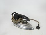 an old fashioned iron with a rope on it
