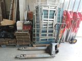 a stack of chairs and a pallet in a garage