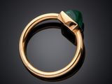 a close up of a gold ring with a green stone