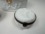 a white box with a lid sitting on a table next to a bowl