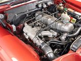 a red car with an engine in it ' s trunk