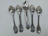 six spoons are lined up in a row on a white surface