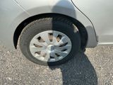a shadow of a person on the ground next to a car