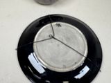 a clock that is sitting on a plate on the table