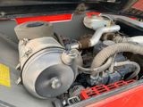a close up of a car ' s engine with its hood open