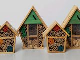 four small wooden houses that are lined up on a table