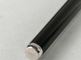 a close up of a pen on a table with a white background