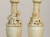 two vases that are sitting on a table