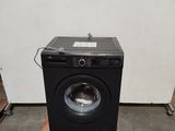 an image of a washing machine sitting on a pallet in a room