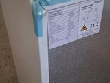 a white refrigerator with a blue handle on it in a room