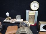 many different types of clocks and other items on the table