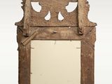 an old wooden mirror with a decorative design on it