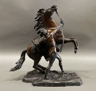 bronze statue of a man on a horse with a spear in his hand