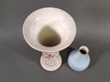 two vases sitting next to each other on a table