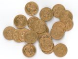 a pile of gold coins on a white surface