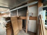 a room with a refrigerator, cabinets, and a refrigerator in it