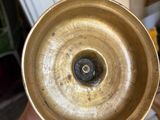 a person holding a brass plate in their hand