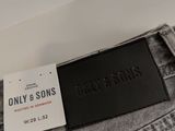 the label on the back of a pair of grey jeans