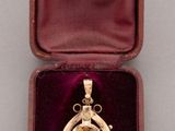 a small box with a necklace and earrings inside of it