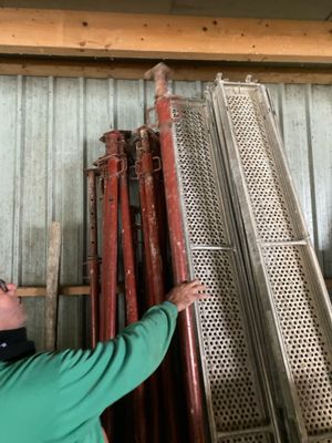 a man that is standing next to a pile of pipes