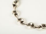 an image of a close up of a chain bracelet on a white surface
