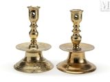pair of antique brass candlesticks on a white background