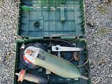 a green box with tools in it sitting on the ground