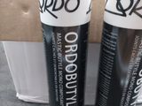 two tubes of black and white hair dye sitting on top of a cardboard box