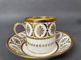 a close up of a coffee cup and saucer on a table