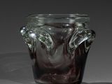 un vase en verre muni d'une anse, posé sur une table