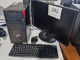 un ordinateur de bureau posé sur une table avec un clavier et une souris