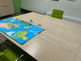 a table with a map on it and green chairs