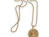 a gold necklace with a lion head on a chain