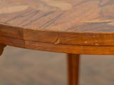 a close up of a wooden table with a clock on it