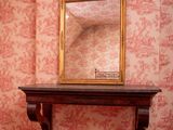 a mirror on a table in a room with a red carpet