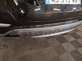 the rear end of a black car with a license plate on it
