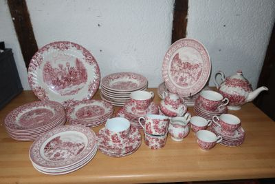 a table with a lot of red and white plates and cups