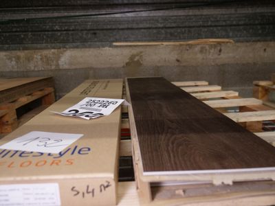 a box of wood sitting on a pallet in a warehouse