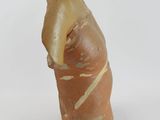 a clay figurine of a man standing on a white surface