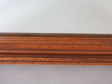an image of a mirror with a wooden frame on a white wall