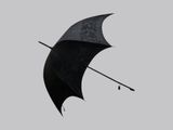 a black umbrella with a black handle on a gray background