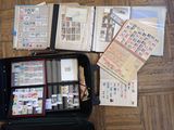 a suitcase full of stamps and papers on the floor