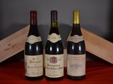 three bottles of wine are sitting on a table next to a wooden box