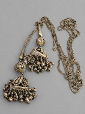 pair of antique silver jhuma earrings and a gold chain necklace
