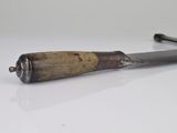 a hammer with a wooden handle on a white surface