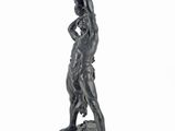 the statue of a woman is standing on a rock with her hands on her hips